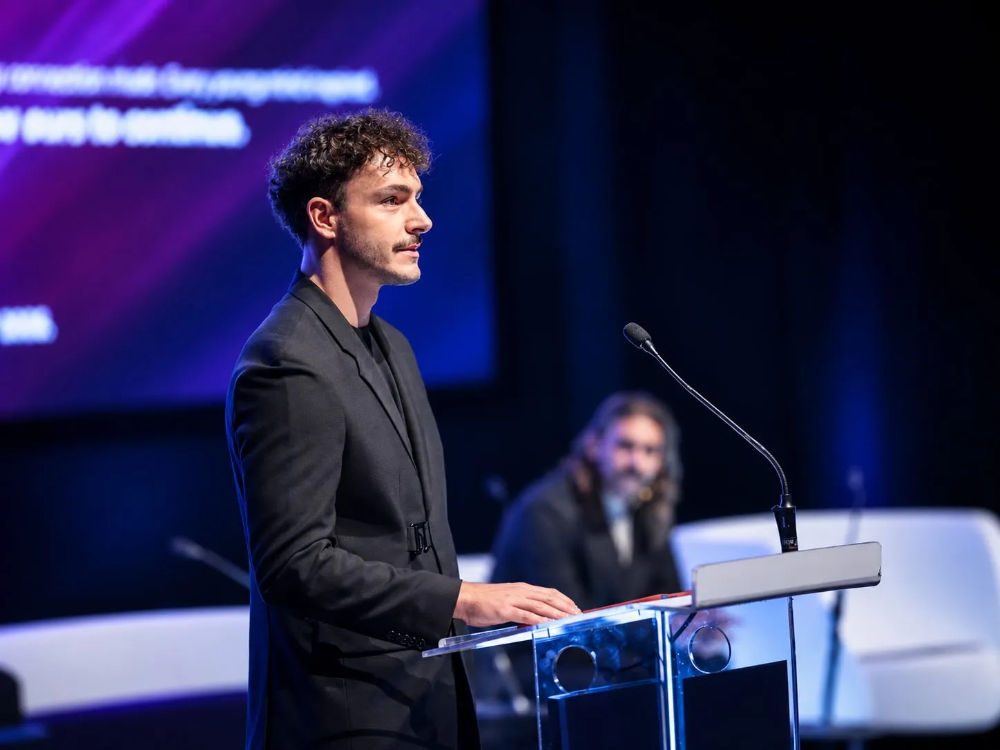 Viktor speaking at a podium